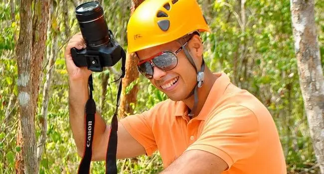 Keshi preparing to take photographs outdoors