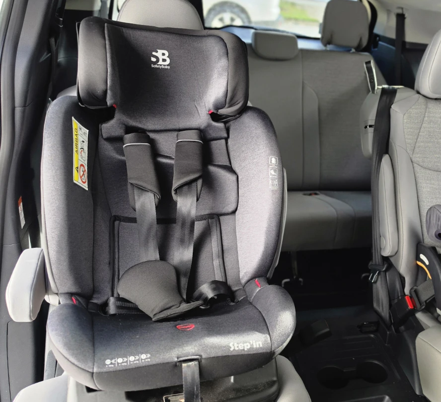 Forward-facing child seat with a harness inside our tour vehicle.