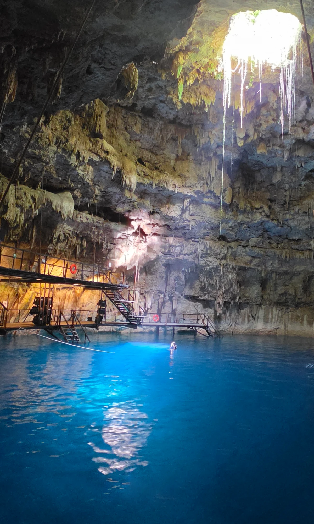 Sunlight entering the tall cavern above the blue water at Hacienda Chukum.