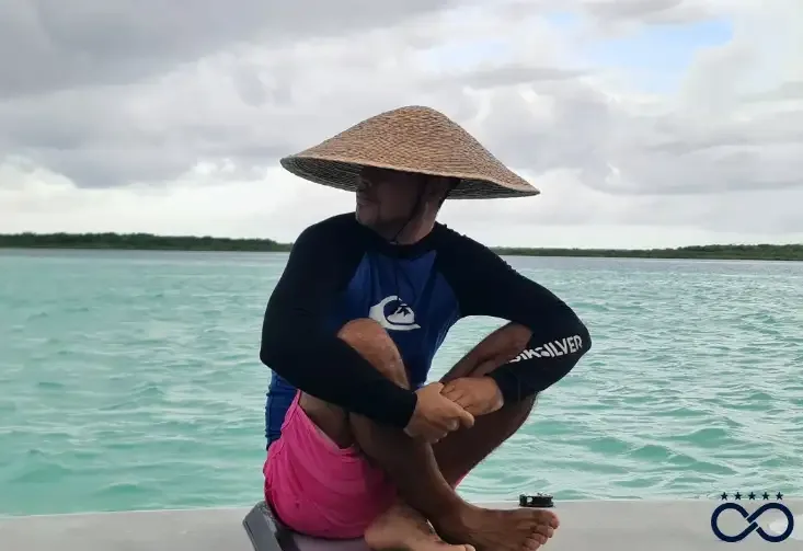 Keshi wearing a hat on a boat in the Riviera Maya