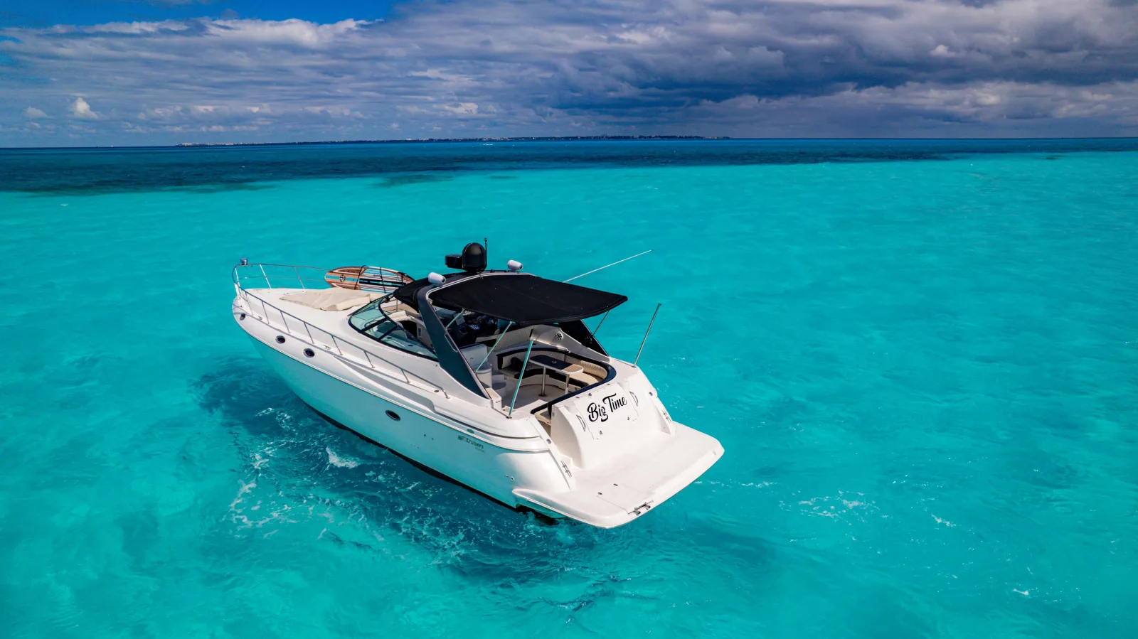 Big Time yacht viewed from the stern on turquoise water