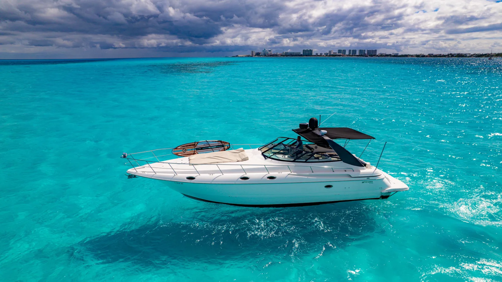 Big Time 46-foot private yacht on turquoise water in Cancún