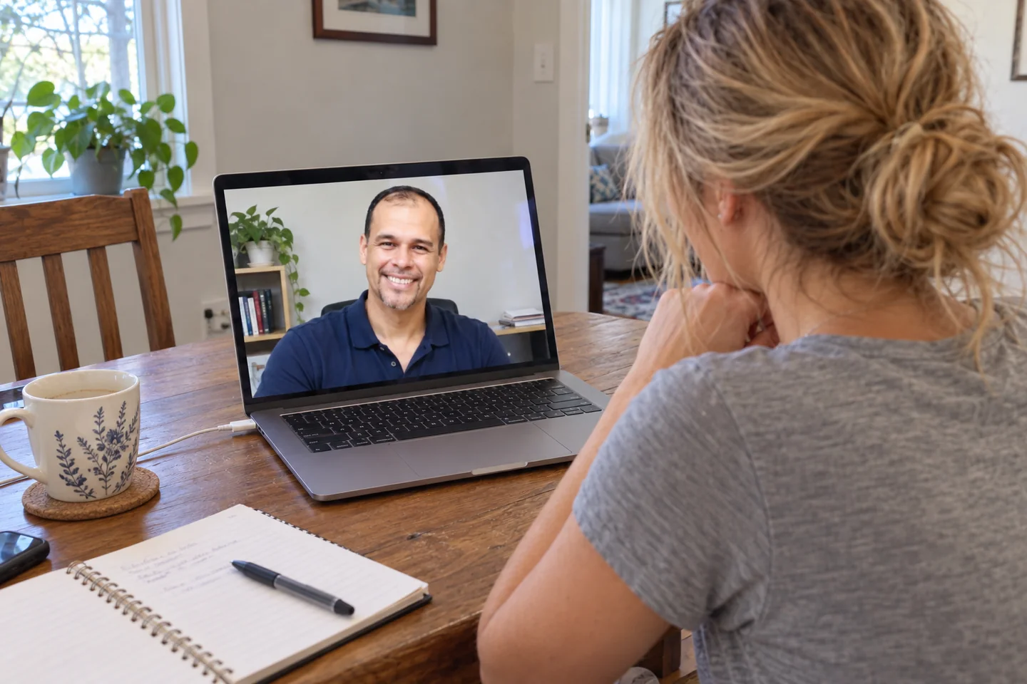 AI illustration: a bride at home discussing her wedding plans on a laptop with Keshi in a simple office.
