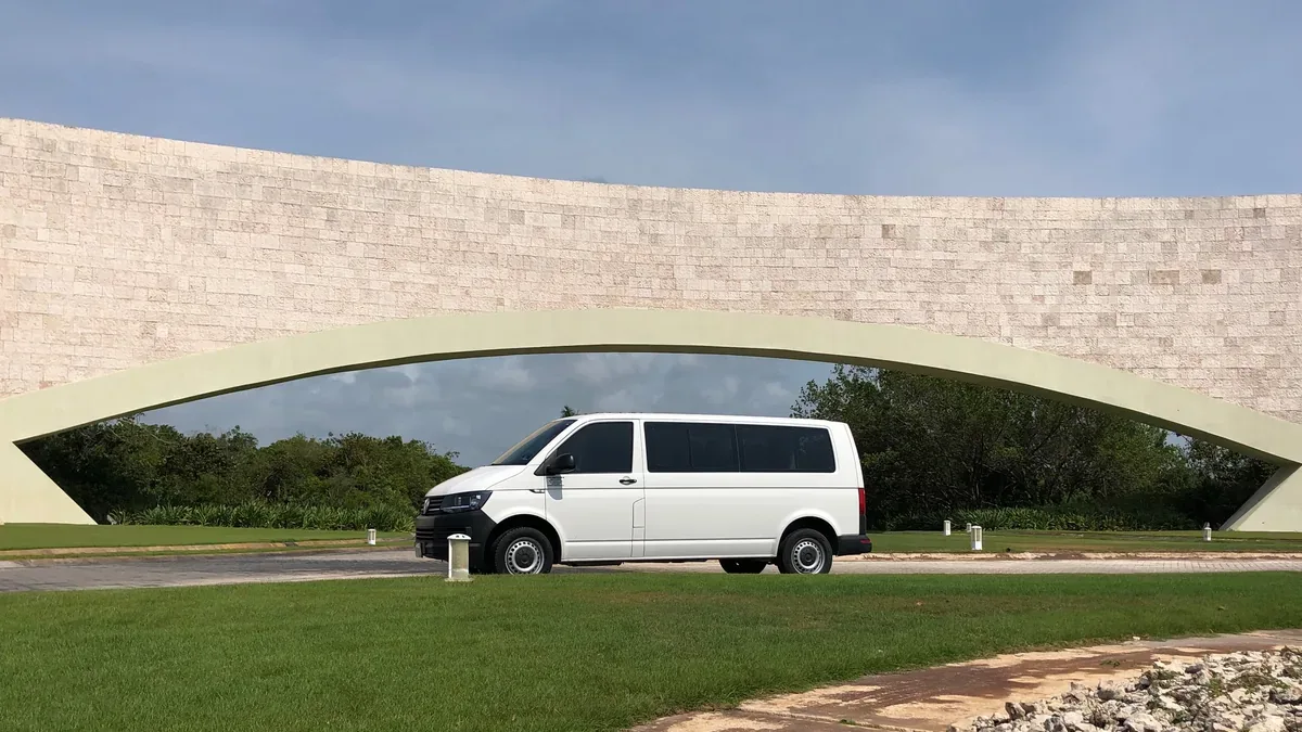 White Volkswagen Transporter outside a hotel entrance